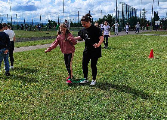 dziewczynki biegną z szarfą