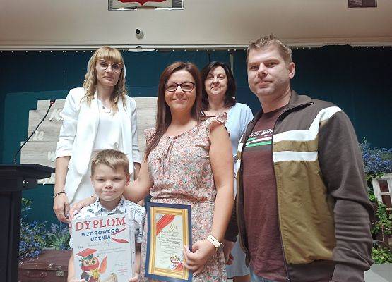 Franciszek Mejna z rodzicami odbiera nagrodę wzorowego ucznia