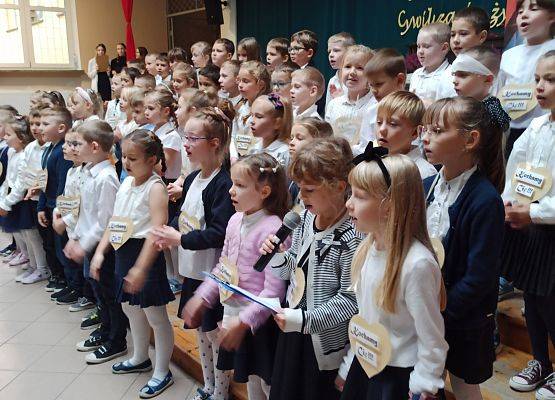 dzieci z klasy 1 śpiewają na apelu