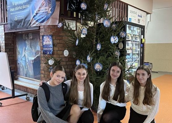 Uczniowie pozują do zdjęcia przy choince