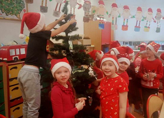 uczniowie ubierają choinkę