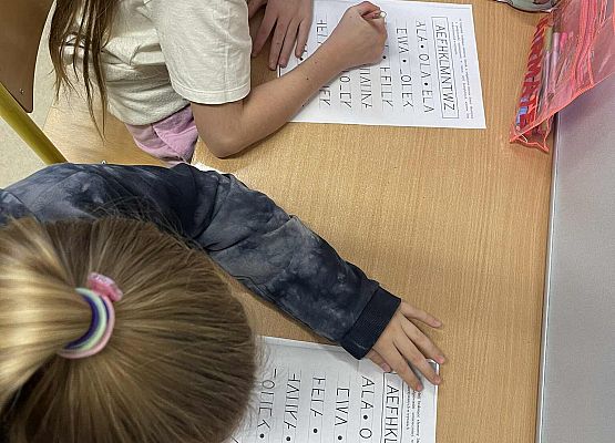 Uczennice rozpoznają i piszą litery.